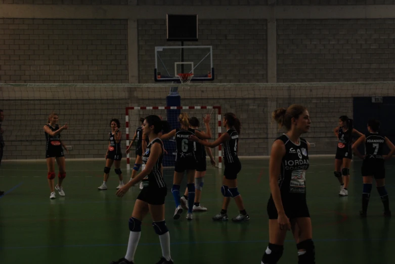 girls in uniforms on a basketball court