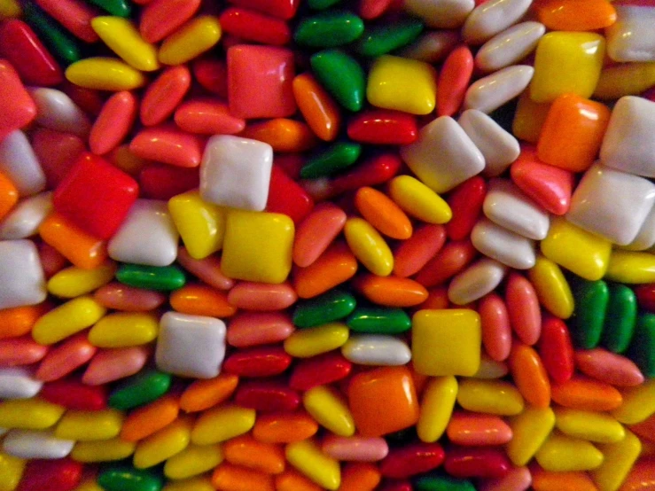 many different colored candy candy on a plate