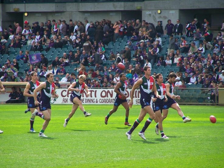 the players running to control the ball on the field