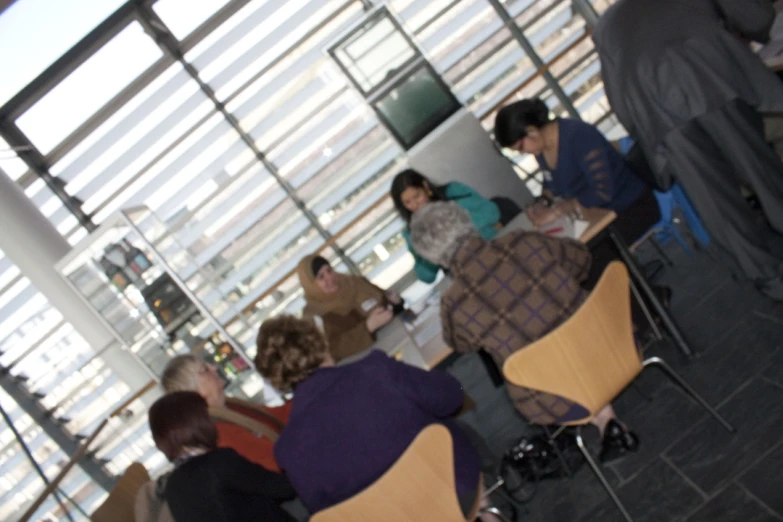 a group of people sitting at a table having a meal together