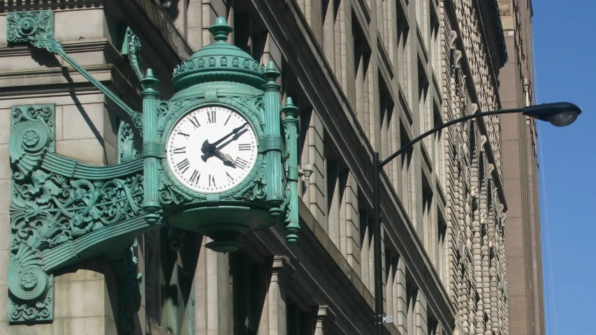 the clock is in an ornate design around the large building