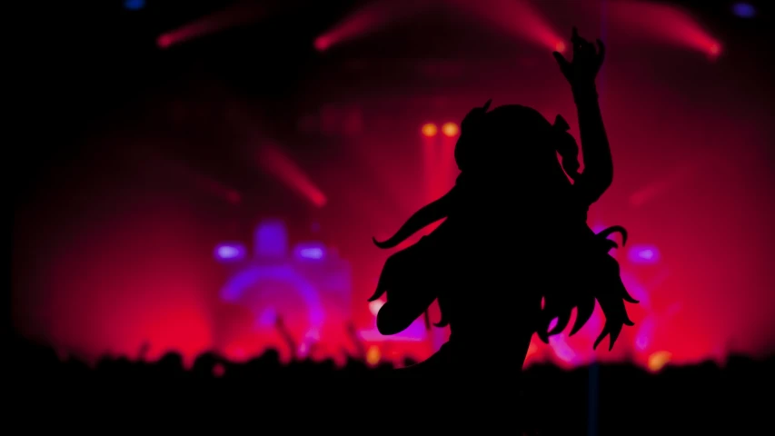 silhouette of woman with hand up in front of bright lighting at event