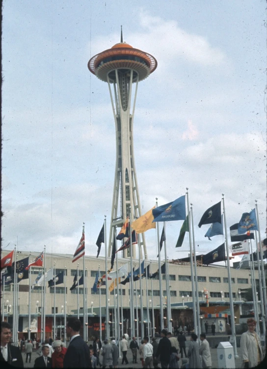 a view of the space needle looking over flags on display