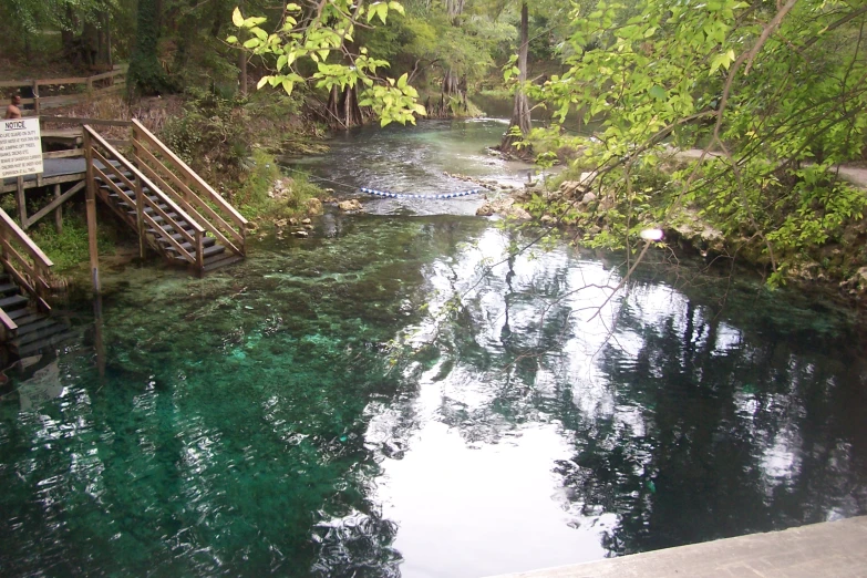 a body of water with wooden steps in it