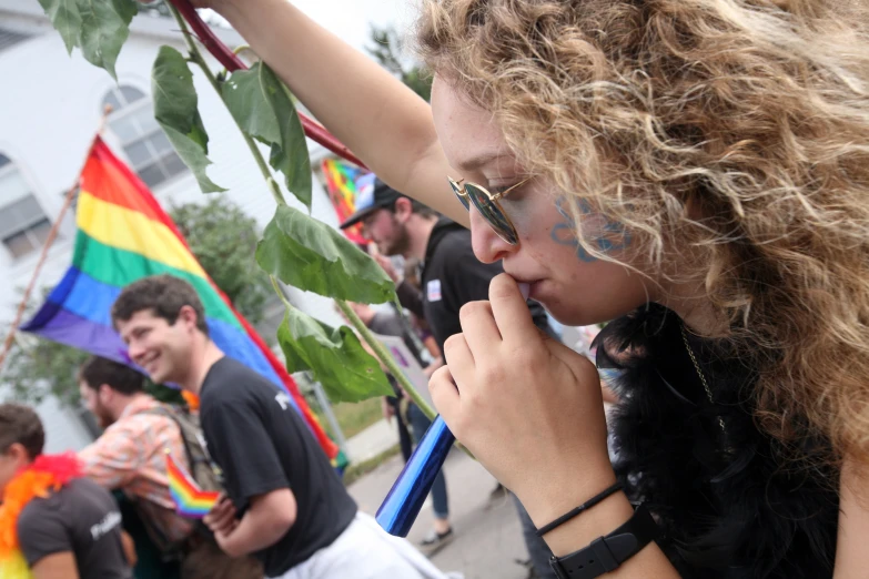 some people holding flags and a woman has her face pressed into the palm of her hands