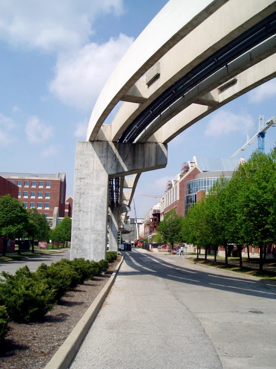 a road under an overpass on top of buildings