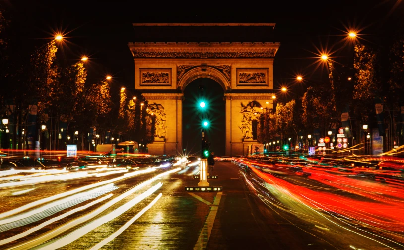 a city street at night filled with traffic and lots of lights