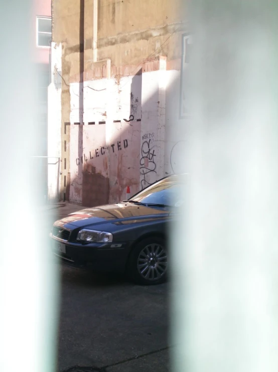 a car parked outside a building under construction