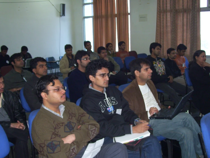 people in chairs sitting with a number of others