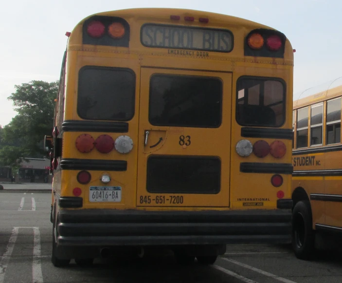 three yellow school buses parked in a parking lot