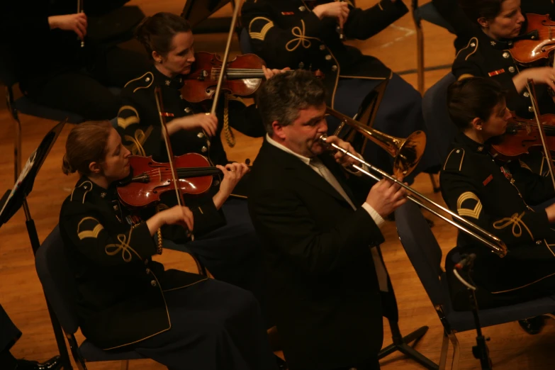 a man in a suit and tie playing an instrument