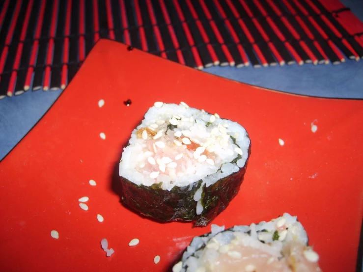 a piece of sushi with some type of rice and green topping