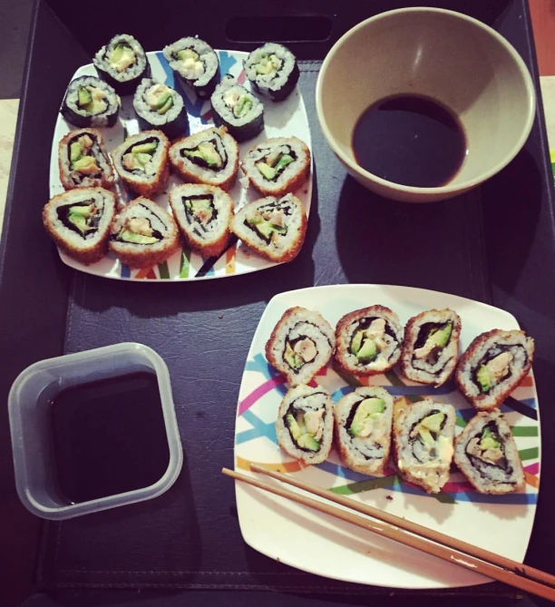 sushi and coffee with chopsticks on a table