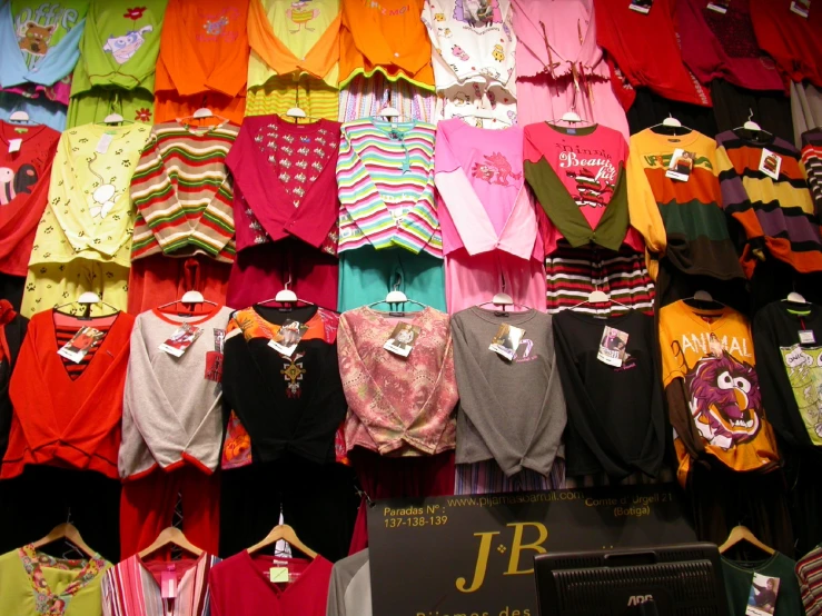 a display of children's shirts and others items