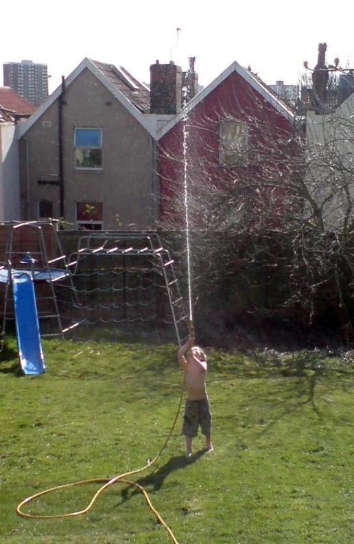 a small  getting ready to hit a flying kite