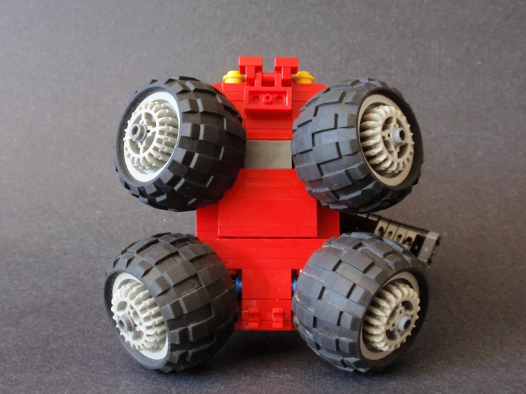 a toy monster truck with six wheels on top of it