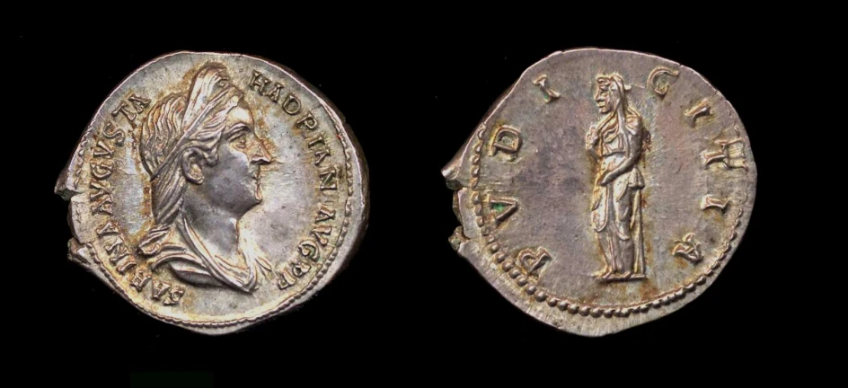 an old, bronze coin with figures on it