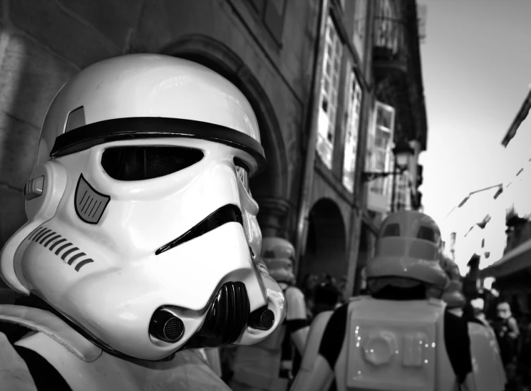 a person in a storm trooper helmet and two smaller people