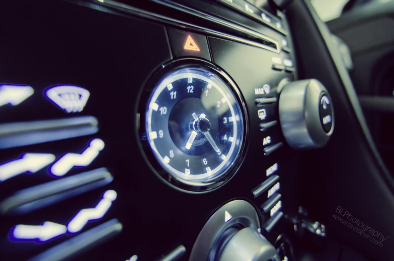a car dashboard showing the time and clock on the dash