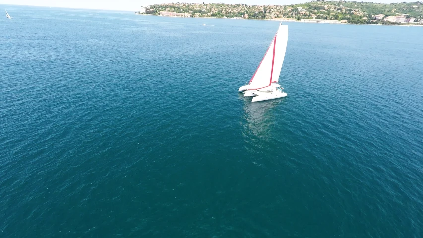 a large sail boat floating across a large body of water