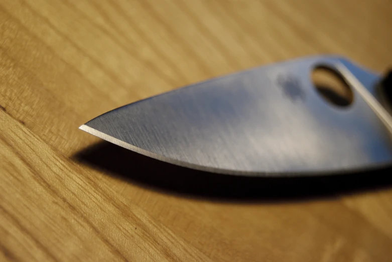 a knife sitting on top of a wooden table