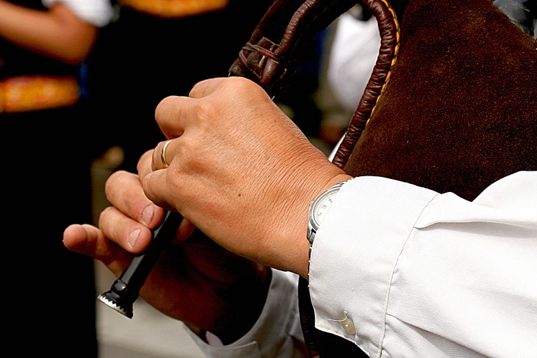 a person holding a large wooden handle with a clock in it