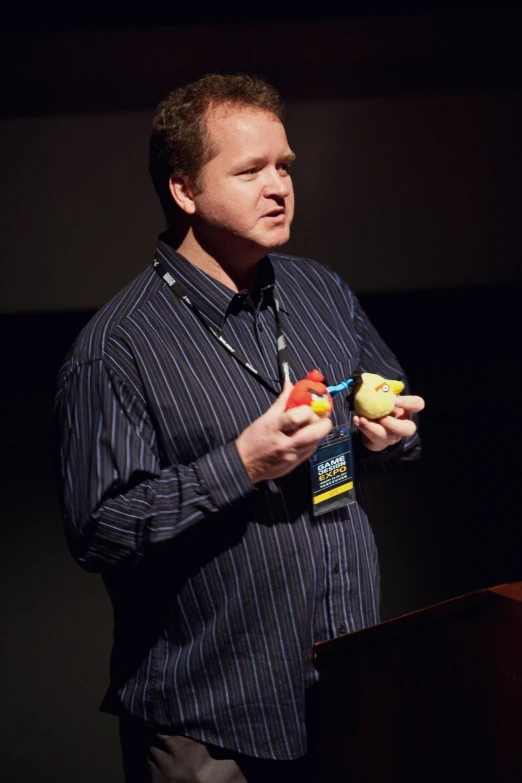 a man standing in front of a microphone holding soing