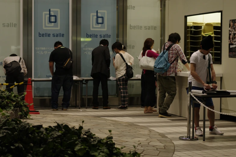 a group of people waiting in line to get in