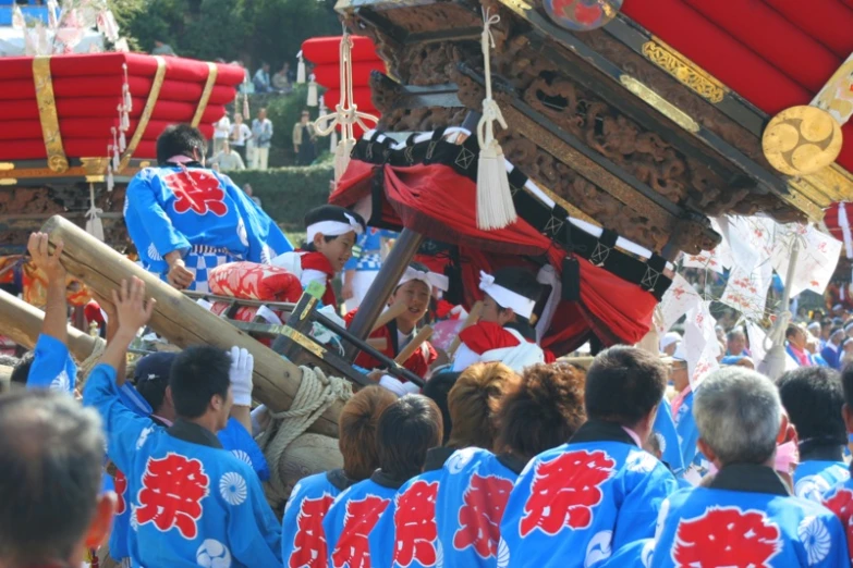 some people wearing red and blue carrying some large objects