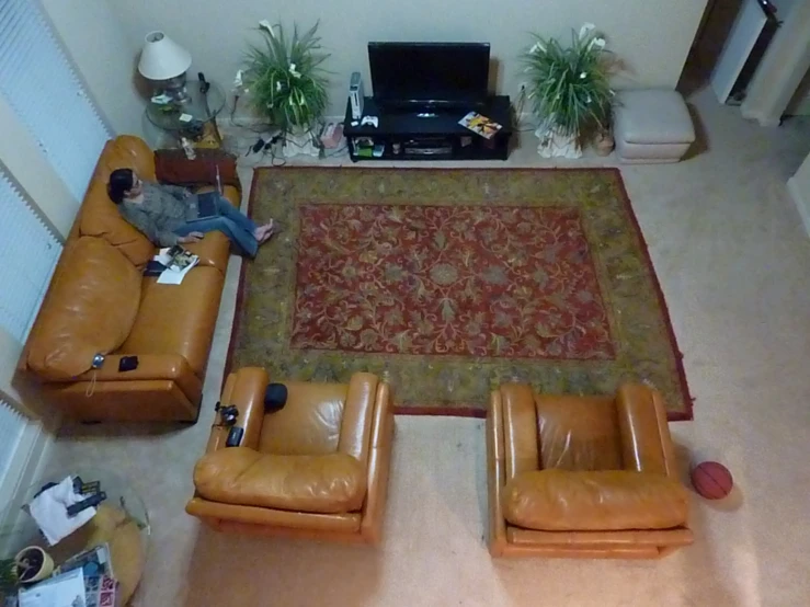 a living room area with two couches and a rug