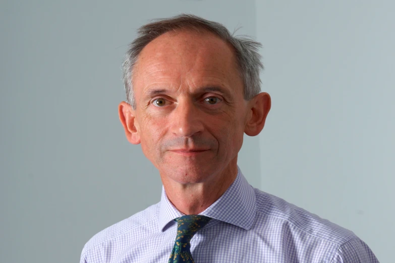 a man in a tie with an odd smirk on his face