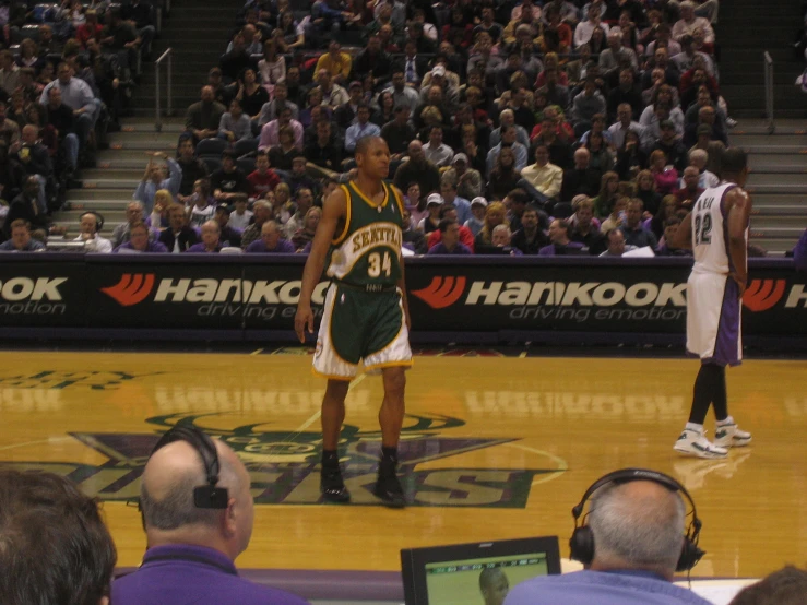 two basketball players standing on the court at a game