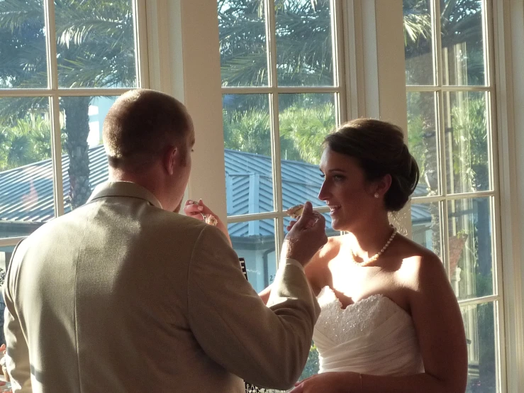 the bride and groom are getting ready to give each other the first piece