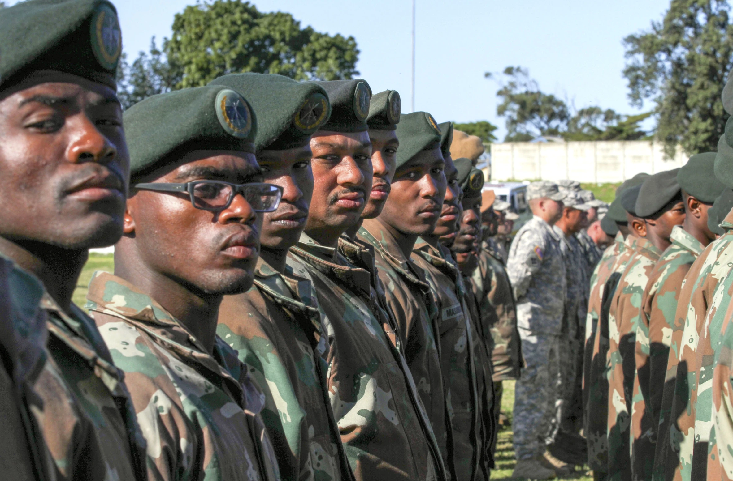 some soldiers are standing in the field,