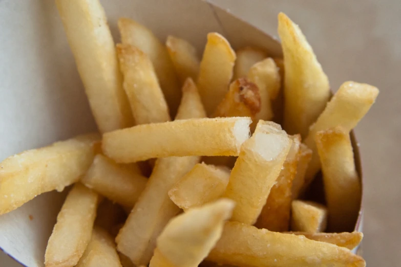 a bowl filled with lots of cut up french fries