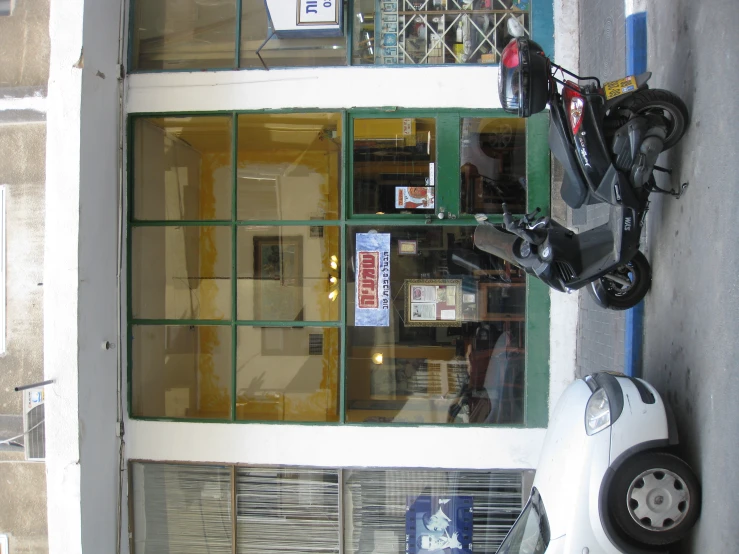 a moped sits parked next to a motor scooter