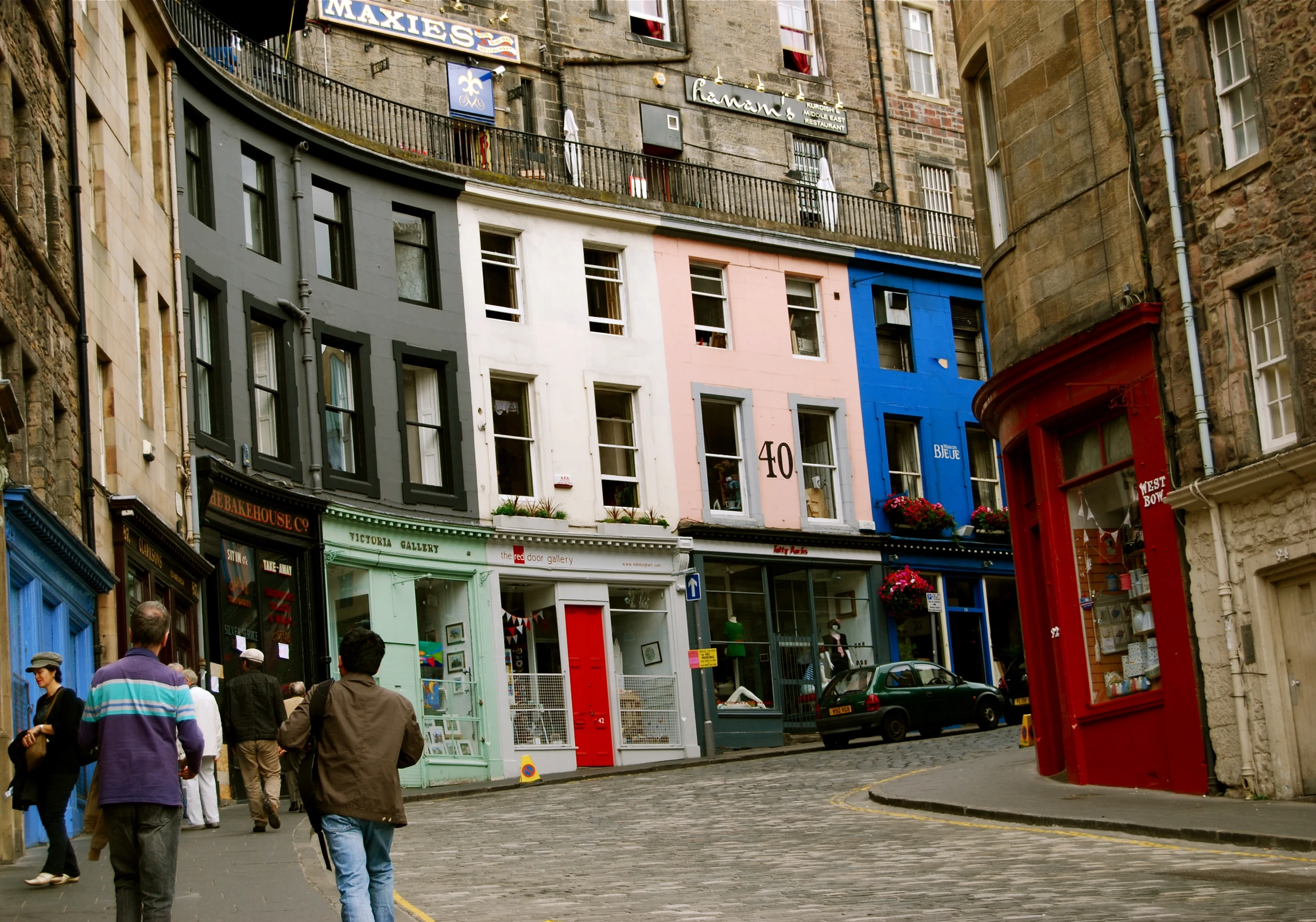 a man walks down a street lined with people in a city