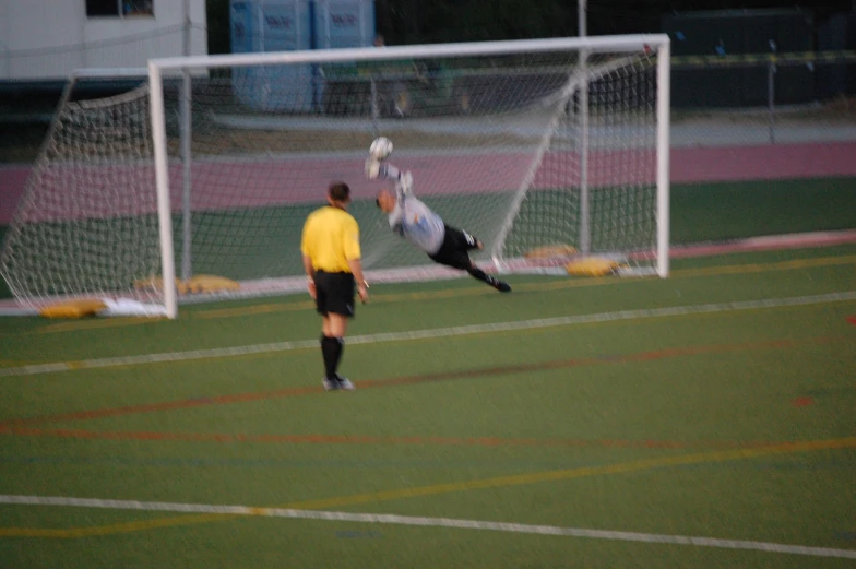 two soccer players are playing on the field