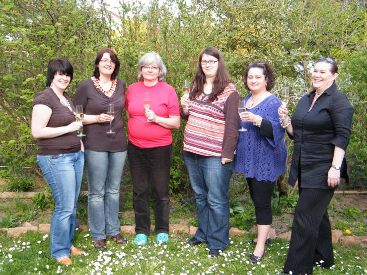 five women are posing with their drinks together