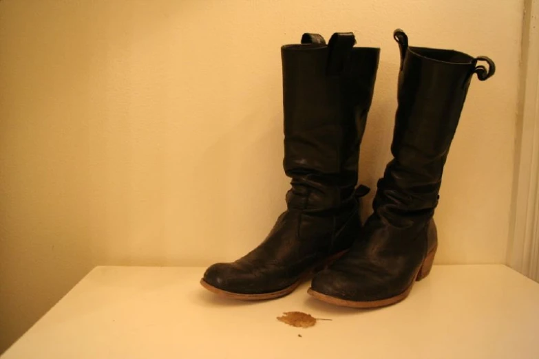 some brown boots are sitting on a shelf