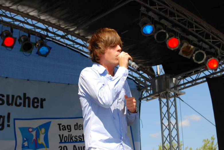 a man holding a microphone up in the air