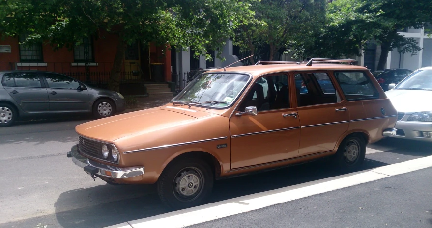 a light orange car is parked in a parking lot