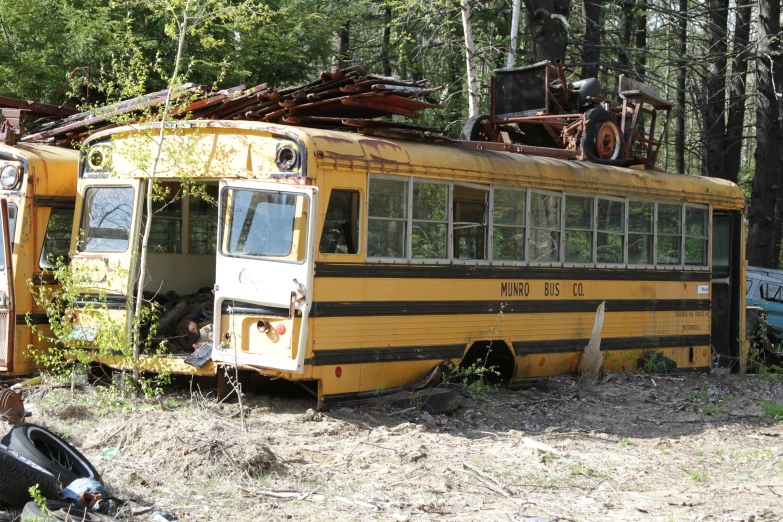 a yellow bus that has rusted on and broken