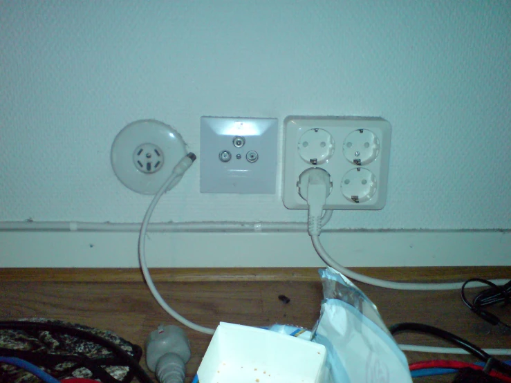 an electrical outlet with two outlets in a corner
