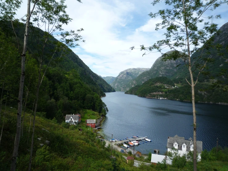 there are mountains surrounding the water and houses