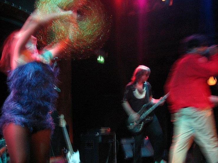 three dancers in a blurry and psychedelic dance