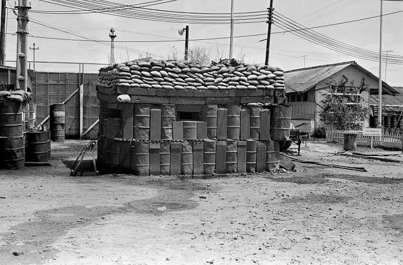 a black and white po of people standing around in the dirt