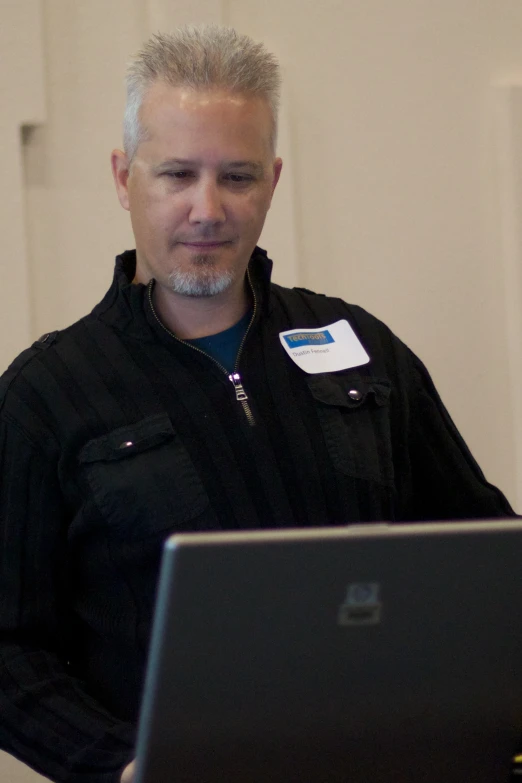 a man using a laptop computer in an office