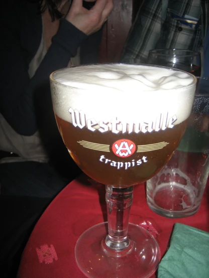a large glass with some type of beer on it
