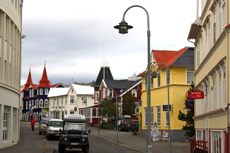 a view down the street to a city with some buildings